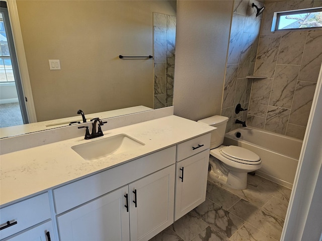 full bathroom with tiled shower / bath, vanity, and toilet