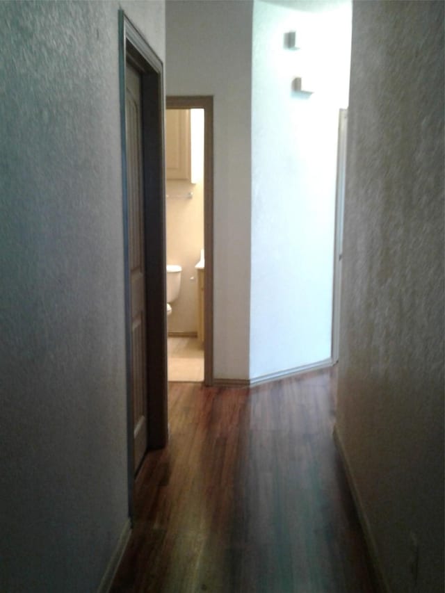 corridor featuring dark hardwood / wood-style flooring