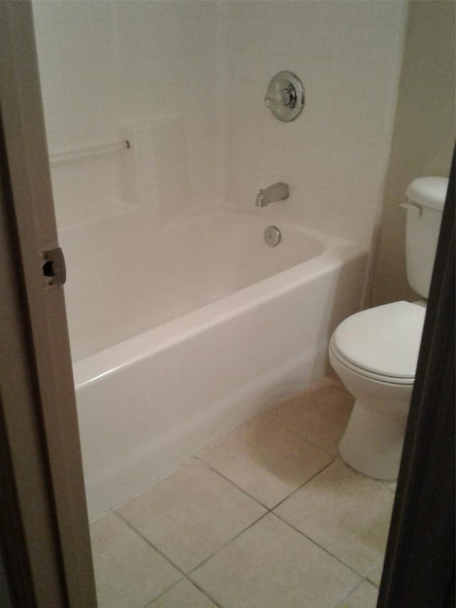 bathroom featuring shower / bath combination, tile patterned floors, and toilet