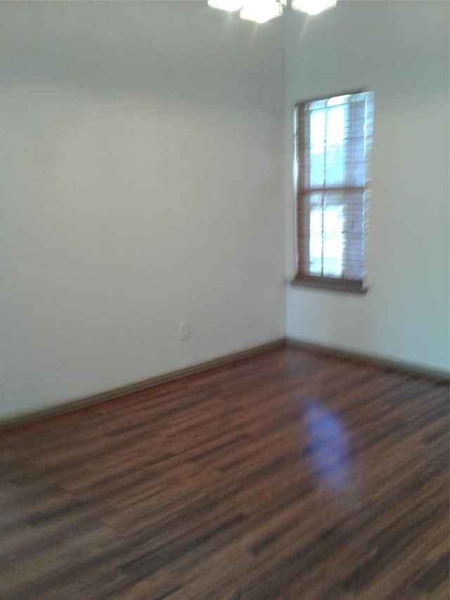 unfurnished room with dark hardwood / wood-style floors