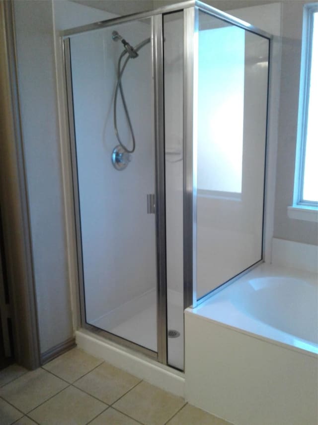 bathroom featuring separate shower and tub and tile patterned flooring