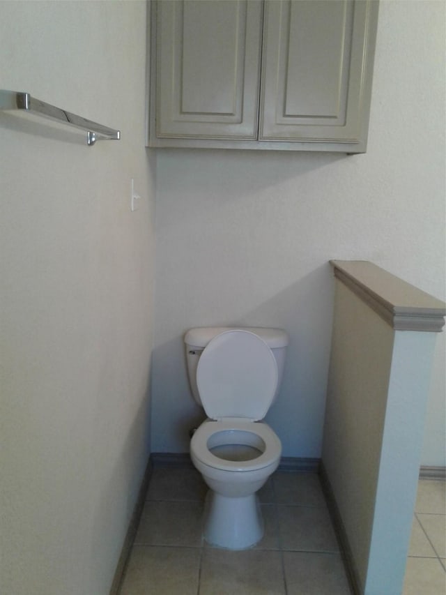 bathroom featuring toilet and tile patterned flooring