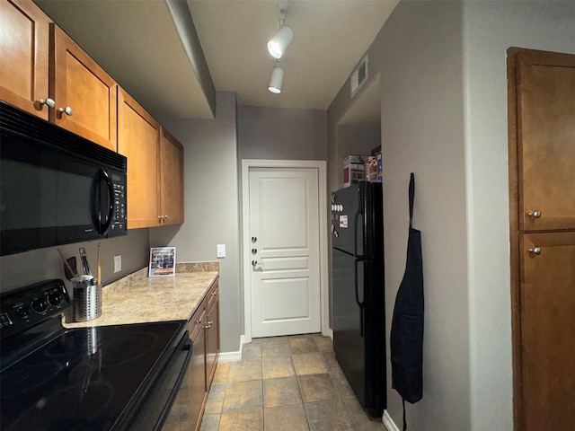 kitchen featuring black appliances and rail lighting