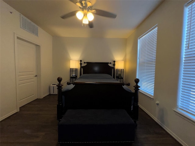 bedroom with dark wood-type flooring and ceiling fan