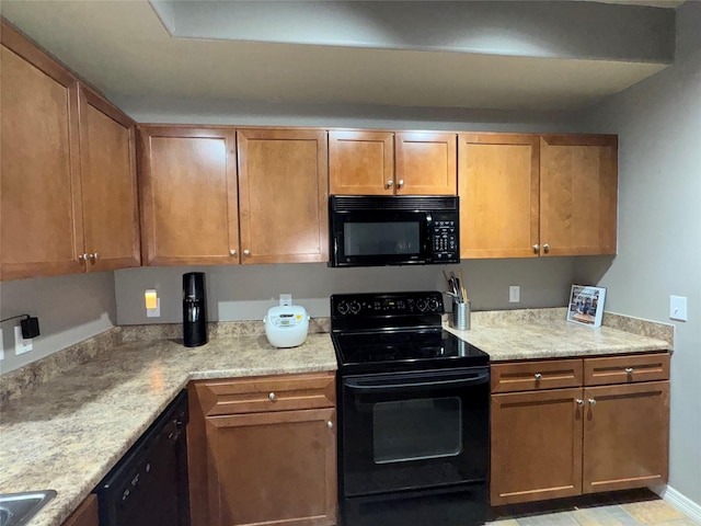 kitchen with light stone countertops and black appliances