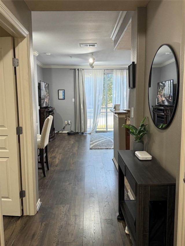 hall featuring ornamental molding and dark hardwood / wood-style floors