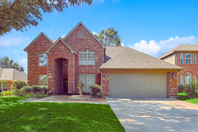 traditional home with a garage, brick siding, concrete driveway, roof with shingles, and a front lawn