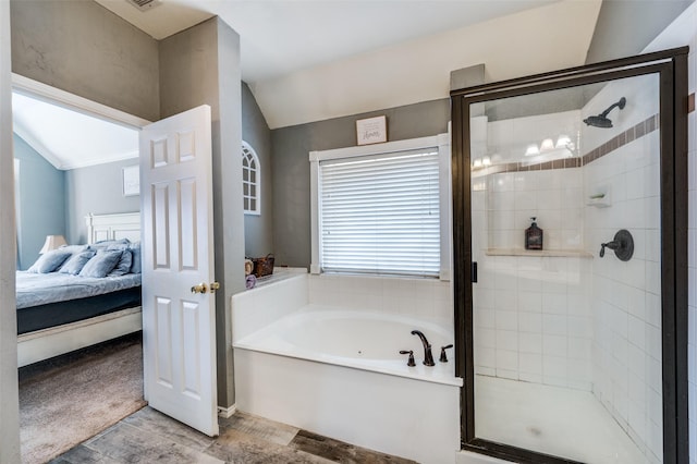 ensuite bathroom with visible vents, vaulted ceiling, connected bathroom, a shower stall, and a bath