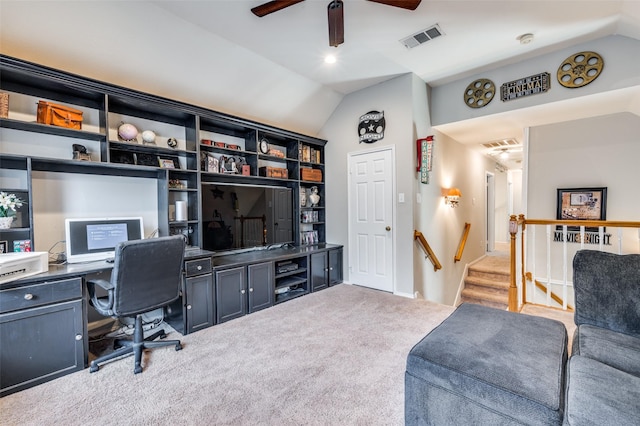 office space featuring light colored carpet, lofted ceiling, and visible vents