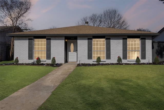 ranch-style house featuring a yard