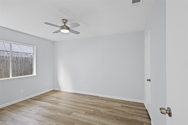 unfurnished room with crown molding, plenty of natural light, ceiling fan, and light wood-type flooring