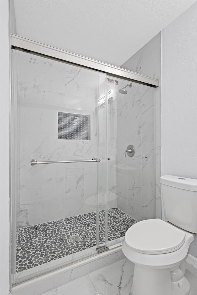 3521 Post Oak Rd, Garland, TX 75044 - bathroom with toilet, a marble finish shower, marble finish flooring, and baseboards