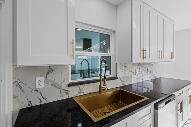 kitchen with backsplash, sink, exhaust hood, and white cabinets