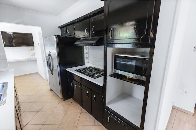 kitchen with stainless steel fridge, tasteful backsplash, ornamental molding, light tile patterned flooring, and black gas stovetop