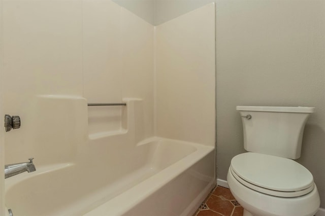 bathroom with shower / bathing tub combination, tile patterned floors, and toilet