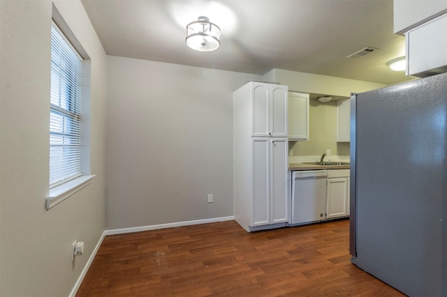 kitchen with stainless steel refrigerator, dishwasher, sink, white cabinets, and dark wood-type flooring