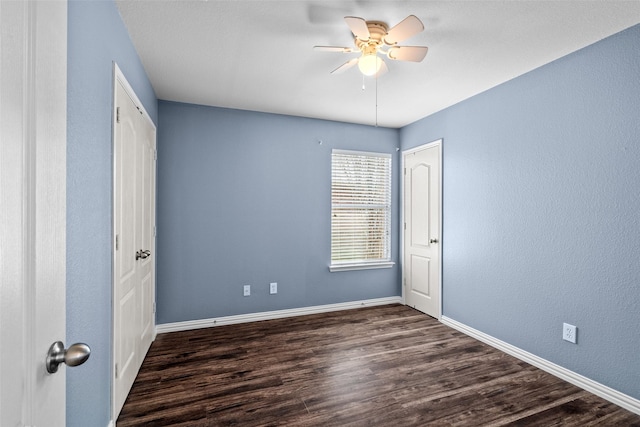 unfurnished bedroom featuring dark hardwood / wood-style flooring, a closet, and ceiling fan