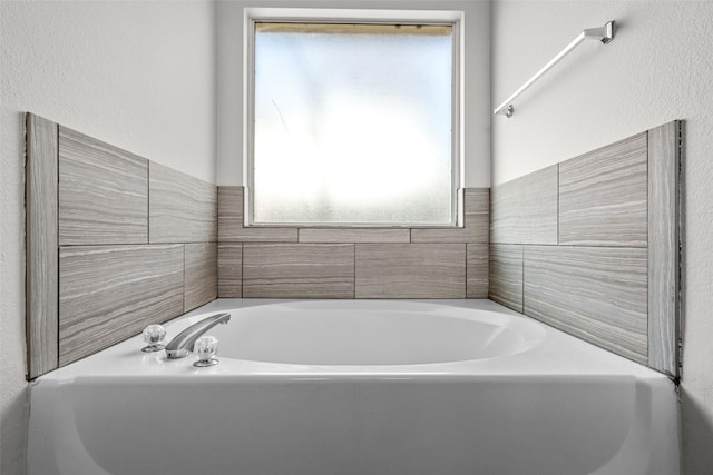 bathroom with a healthy amount of sunlight and a bathtub