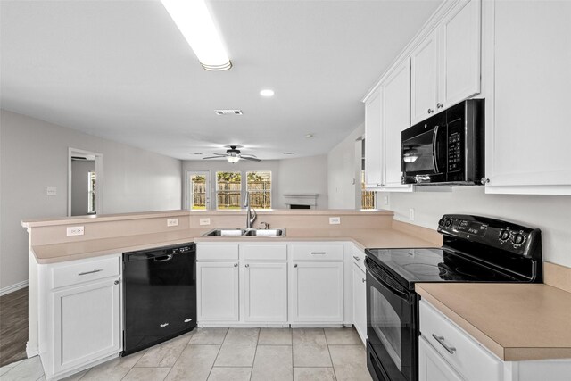 kitchen featuring black appliances, white cabinetry, sink, hanging light fixtures, and kitchen peninsula