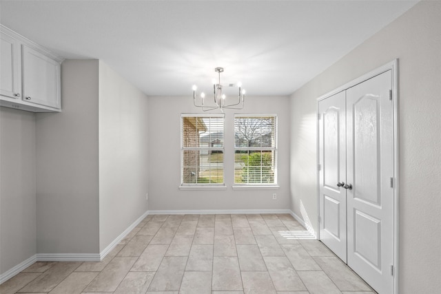 unfurnished dining area featuring a notable chandelier