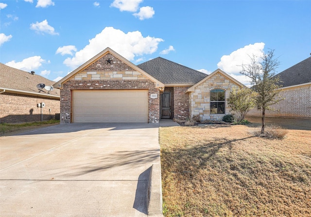 french provincial home featuring brick siding, a shingled roof, a front lawn, concrete driveway, and an attached garage