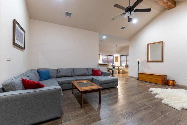 living room with dark hardwood / wood-style flooring, beam ceiling, high vaulted ceiling, and ceiling fan