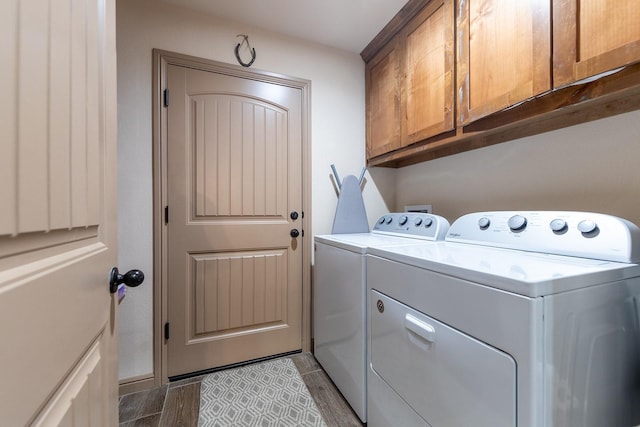 washroom with washer and clothes dryer and cabinets