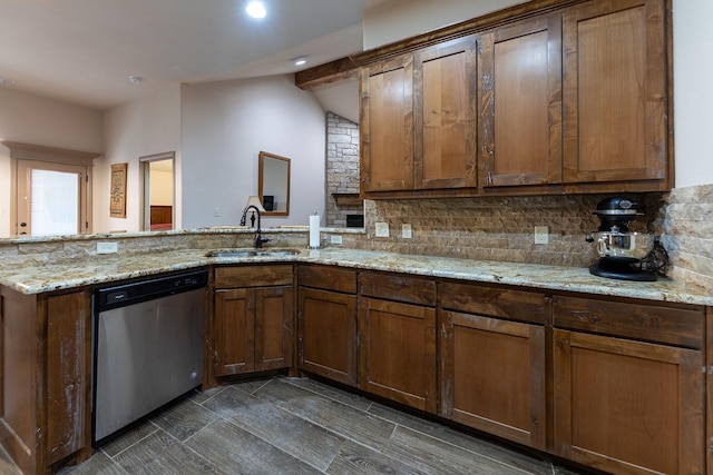 kitchen with sink, backsplash, light stone countertops, stainless steel dishwasher, and kitchen peninsula