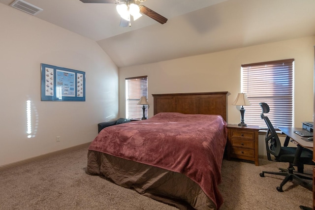 carpeted bedroom with ceiling fan and vaulted ceiling