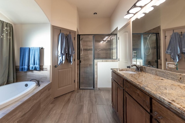 bathroom featuring vanity and shower with separate bathtub