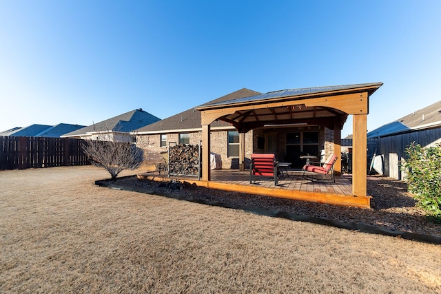 rear view of property with solar panels