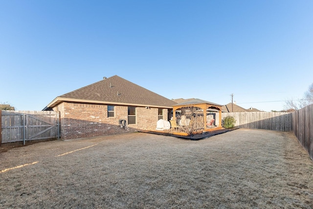 back of property with a gazebo