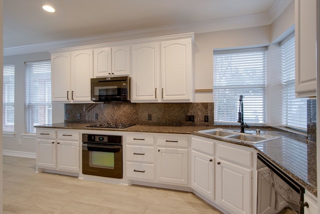 kitchen featuring sink, backsplash, ornamental molding, black appliances, and white cabinets