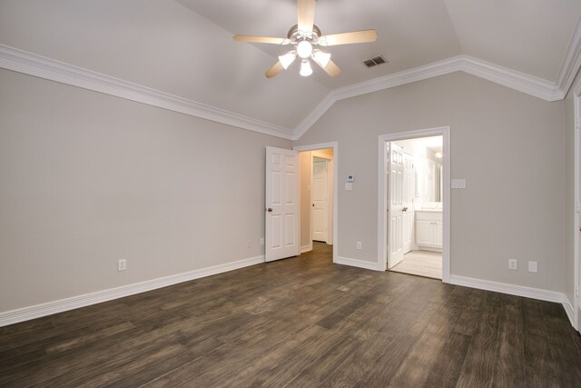 unfurnished bedroom featuring ceiling fan, ensuite bath, dark hardwood / wood-style flooring, and vaulted ceiling