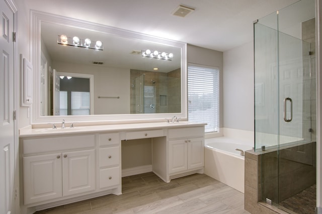 bathroom featuring vanity and plus walk in shower