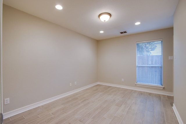 unfurnished room with light wood-type flooring