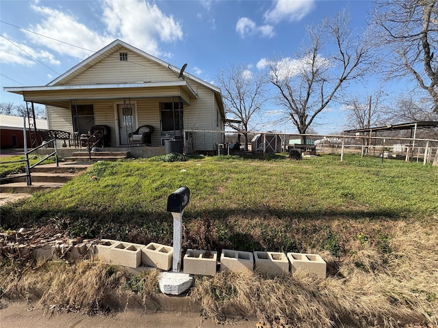 view of front of house featuring a front yard and covered porch