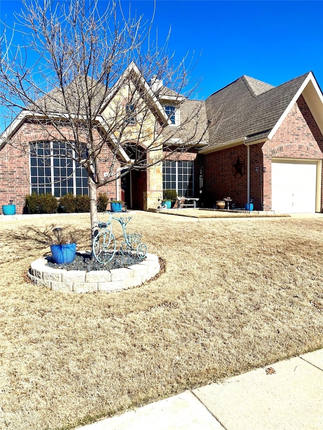 view of front of home featuring a garage and a front yard