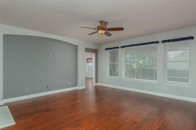 spare room with ceiling fan and dark hardwood / wood-style flooring