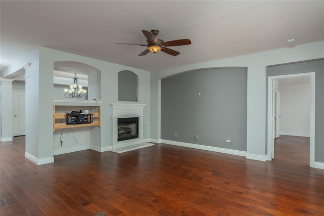 unfurnished living room featuring dark hardwood / wood-style flooring and ceiling fan with notable chandelier