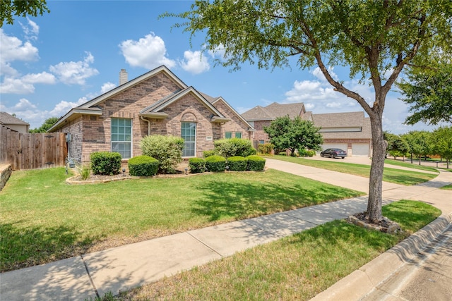 view of front of property with a garage and a front yard