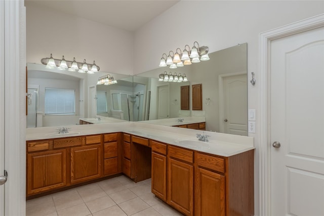 bathroom featuring vanity, an enclosed shower, and tile patterned floors