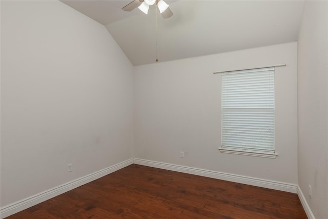 empty room featuring lofted ceiling, dark wood-type flooring, and ceiling fan