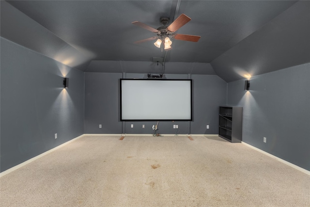 carpeted cinema featuring lofted ceiling and ceiling fan