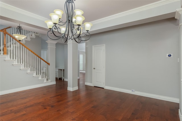 unfurnished dining area featuring ornate columns, ornamental molding, dark wood-type flooring, and an inviting chandelier