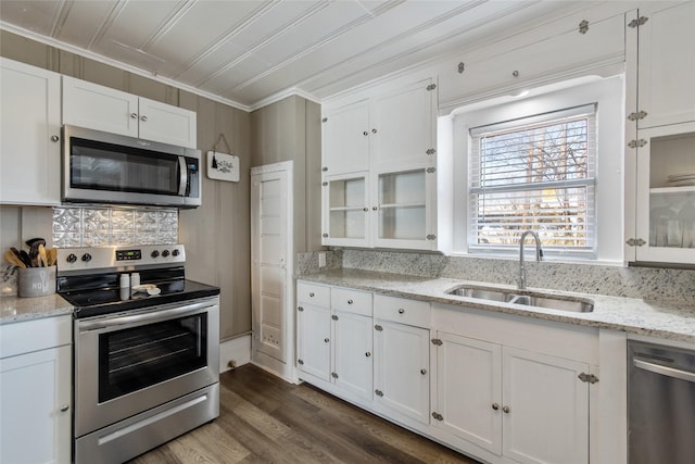 kitchen with sink, white cabinets, dark hardwood / wood-style flooring, stainless steel appliances, and light stone countertops