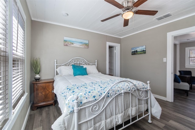 bedroom featuring dark wood-type flooring, ceiling fan, and ornamental molding