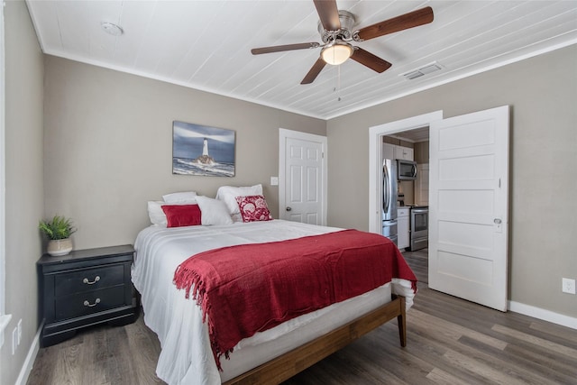 bedroom featuring dark wood-type flooring, stainless steel refrigerator, and ceiling fan