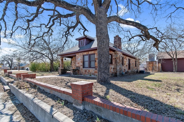 view of side of home with a yard