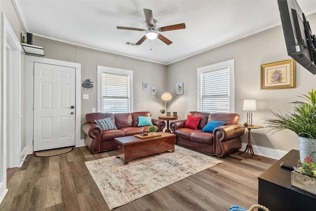 living room featuring ornamental molding, hardwood / wood-style floors, and ceiling fan